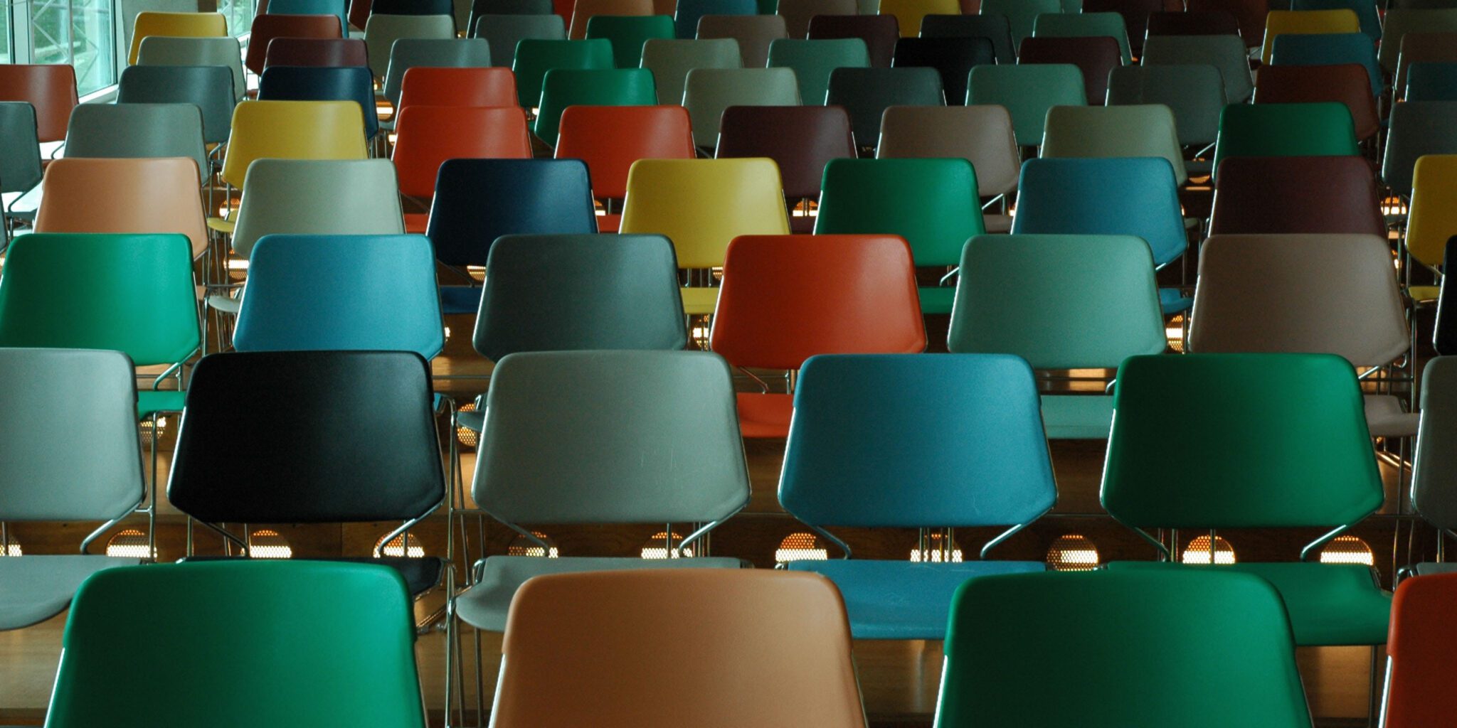 Empty chairs in a college classroom. This page displays information about funding for college students.